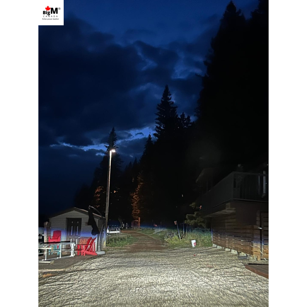 Image of BigM 1200W solar commercial street lights installed on a hydro pole. The light is on in low mode with 30% brightness. This will get brighter when senses motion around.
