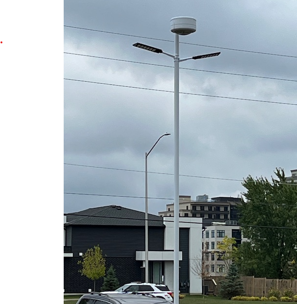 Image of 2 units of BigM 1200W solar commercial street lights installed on a long hydro pole in a church parking lots at London, Ontario. (photo courtesy BigM customer)