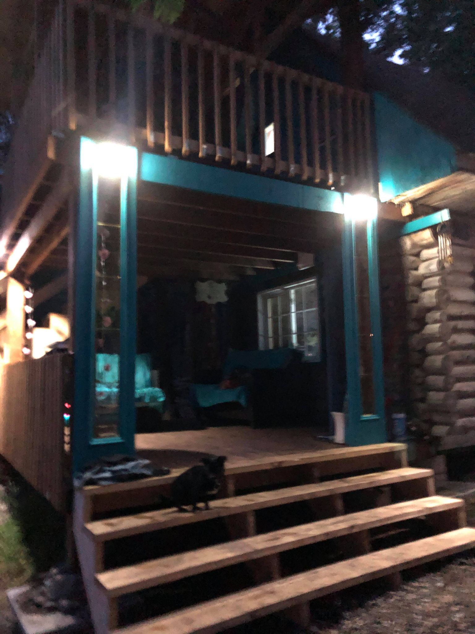 BigM  212 LED Solar Security Light is installed at the entrance of a cottage and lights up at night