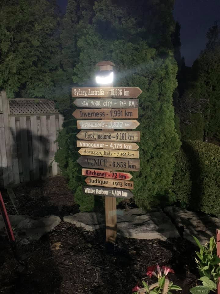 BigM  212 LED Solar Light is on in constant light mode at the top of a signage