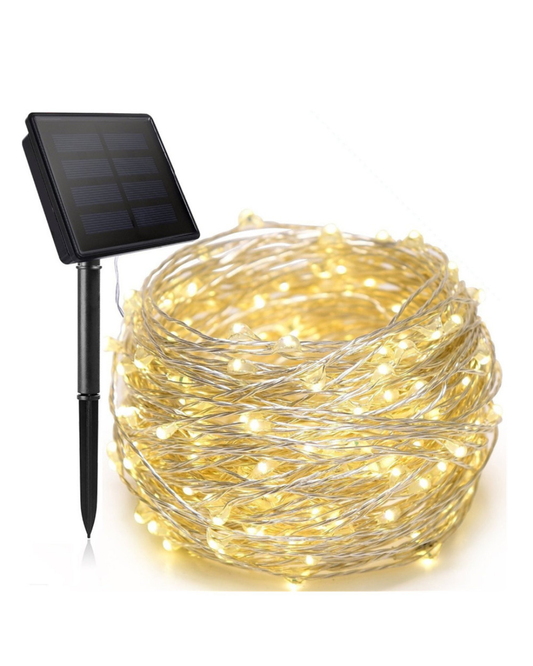 BigM LED Solar Copper Fairy String Lights glowing warmly on patio and garden fence at night