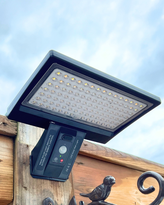 BigM Solar Wall Lamp for Outdoor Security with Motion Sensor & Adjustable Color Temp installed on the top of a post on the pathway