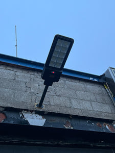BigM  500W Solar Flood Lights with Motion Sensor for Outdoors is installed at the front door of auto mechanic shop