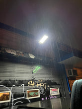 Load image into Gallery viewer, BigM heavy duty 500w Solar Street Lights installed at the front door of a automobile mechanic shop and generates bright light at nightbright light
