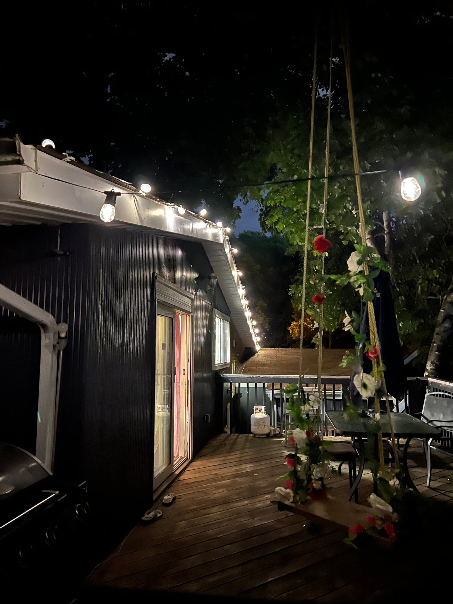 BigM 64 ft Solar Patio String Lights Installed at the edge of a roof to light up a deck