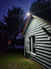 Load image into Gallery viewer, BigM 100W Bright LED Outdoor Solar Street Light installed at the exterior of a cottage
