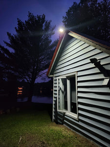 BigM 100W Bright LED Outdoor Solar Street Light installed at the exterior of a cottage