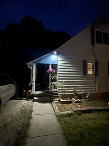 BigM 100W Bright LED Outdoor Solar Street Light installed at the front yard of a house
