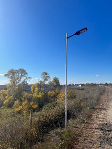 BigM 400W Solar Flood Lights with Motion Sensor are installed on a rural county road at Alberta 