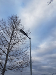 BigM heavy duty 1200w solar street light is installed  on a metal pole at a commercial parking 