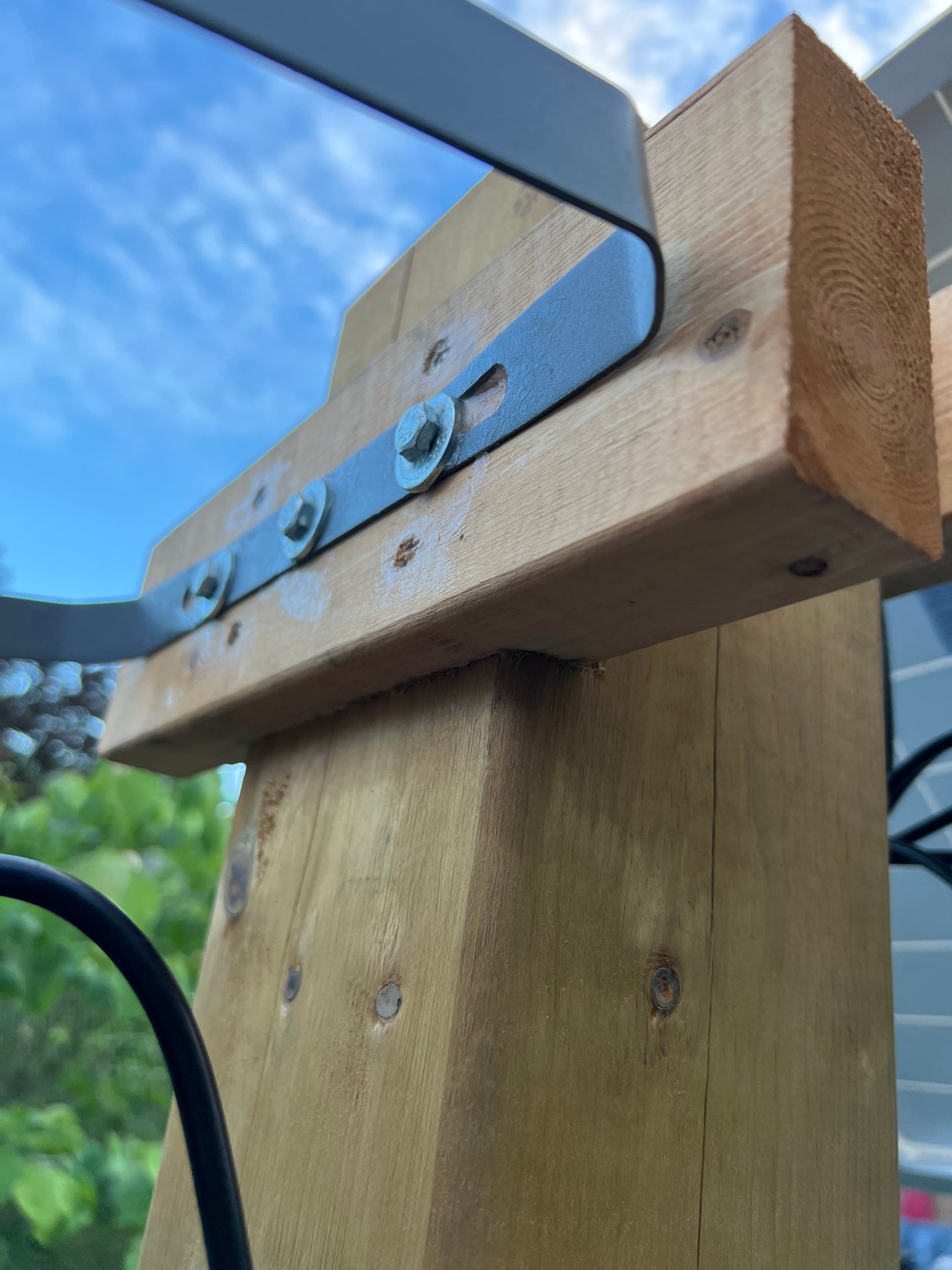 BigM 1500W High Lumens Solar Flood Light is installed on a 2x4 wood bar on a 16 ft lon 6 x 6 post  
