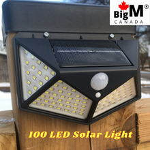 Load image into Gallery viewer, Image of a BigM Super Bright Wireless 100 LED Solar Lights with Motion Sensor installed on a 6x6 post
