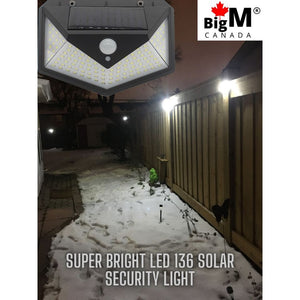 BigM Bright 136 LED Solar Security Light with Motion Sensor lights up a pathway at night
