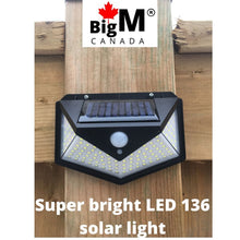 Load image into Gallery viewer, BigM Bright 136 LED Solar Security Light is installed at the backyard of a house
