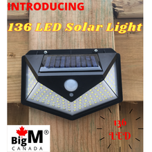 Load image into Gallery viewer, BigM Bright 136 LED Solar Security Light is installed on the pathway of a house
