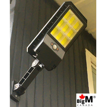 Load image into Gallery viewer, BigM 100 W solar street light installed at the backyard of a house
