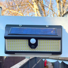 Load image into Gallery viewer, BigM 190 LED Bright Outdoor Solar Security Lights with Motion Sensor installed above a garage doors
