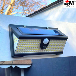 BigM 190 LED Bright Outdoor Solar Security Lights with Motion Sensor installed on a sidewalk to basement