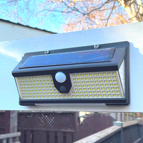 BigM 190 LED Bright Outdoor Solar Security Lights with Motion Sensor installed above a side entrance of a house