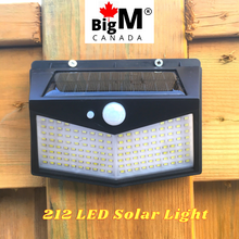 Load image into Gallery viewer, BigM  212 LED Best Solar Security Light is installed on the fence post of a house
