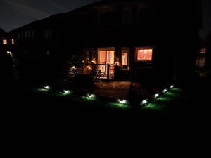 BigM  212 LED Best Solar Security Light With Motion Sensor installed around deck of a trailer house. Lights are on in low mode at this moment in the picture. This low mode will turn bright when sensing motion