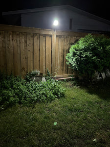 Night view of BigM 100w solar powered super bright mini street light installed by customer on the top of fence post