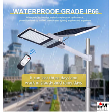 Load image into Gallery viewer, Image of BigM 300W &amp; 15000 Lumens Commercial Graded Solar Street Light with a Large Solar Panel, remote, 25000mah Batteries, Aluminum Lamp Body on a street
