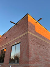 Cargar imagen en el visor de la galería, Image of BigM 700w solar parking lot lights are installed at the outside of a commercial building
