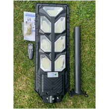 Load image into Gallery viewer, Image of BigM 700w solar parking lot lights with metal brackets, remote, hardwares and booklets
