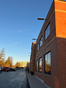 Image of BigM 700w solar parking lot lights are installed at the exterior of a commercial building