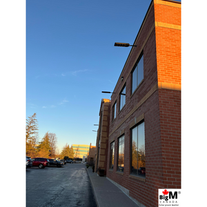 Image of BigM 900W Commercial Grade Solar Street Lights installed at the outside wall of a commercial building