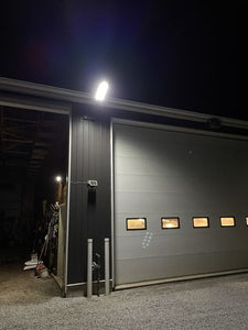 Image of BigM 900W Commercial Grade Solar Street Lights installed at the exterior of a commercial building focusing on the parking lot