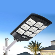 Load image into Gallery viewer, BigM 900W LED Commercial Solar Flood Lights with a metal handle can be installed on a pole easily
