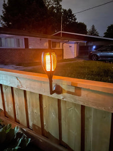 BigM 96 LED Solar Dancing Flame Lights mounted on a fence wall