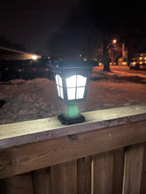 Load image into Gallery viewer, BigM Elegant Vintage Style Solar Post Lights for Outdoors glows elegantly at night at the top of a fence post
