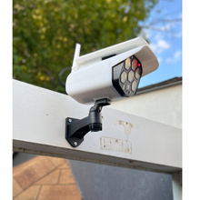 Charger l&#39;image dans la galerie, BigM Solar Powered  Fake Security Camera Floodlight is installed above a door
