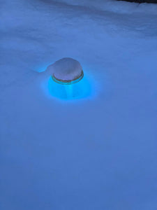 BigM RGB Color Changing Solar Mushroom Lights are glowing to turquoise color in the snow