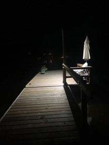Night view of BigM 100 w street light that being installed by customer by the lake on a deck