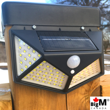 Load image into Gallery viewer, Image of a BigM Super Bright Wireless 100 LED Solar Lights with Motion Sensor installed on a fence post
