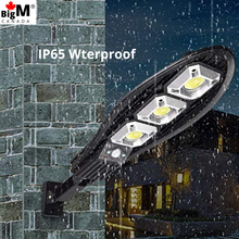 Load image into Gallery viewer, Image of IP65 waterproof BigM 100W solar street flood light can survive through rainy and snowy conditions in Canada
