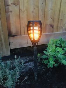 BigM LED Solar Powered Flickering Flame Lights is turn on at night in a garden